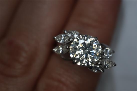 An 18ct white metal and single stone diamond ring, with marquise cut diamond set shoulders, size H/I.